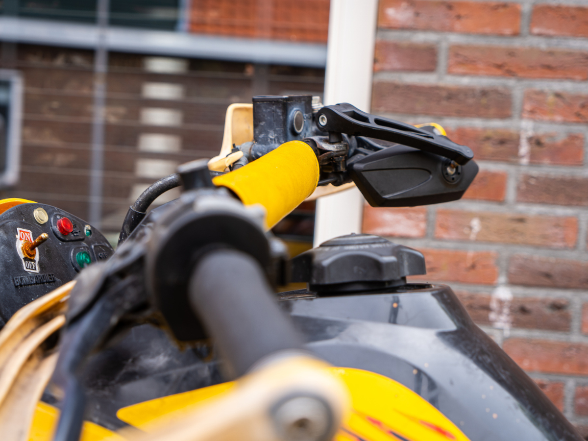 ATV steering controls and handlebar grip shown in detail for maintenance and operation guidance
