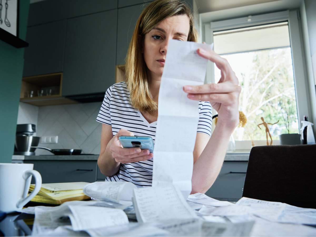 Homeowner reviewing expenses and paperwork related to Property Insurance Claims after property damage