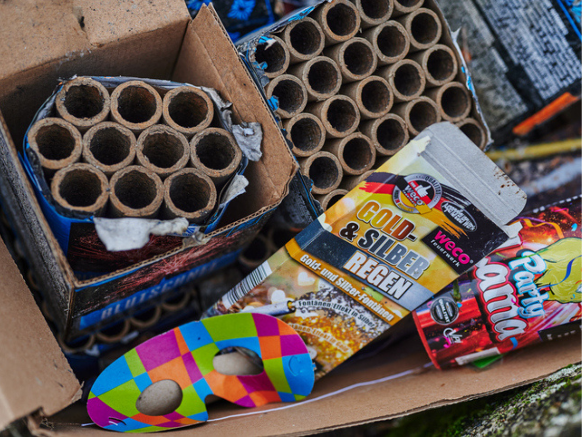 Assorted Firework tubes and packages arranged in a box before a celebration.
