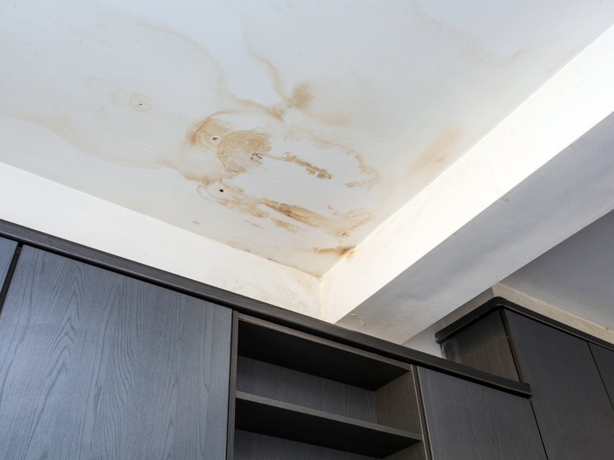 Ceiling stains and discoloration caused by Water Damage above kitchen cabinets