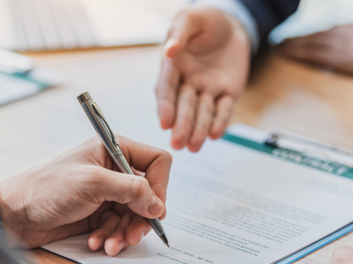 Person reviewing and signing a residential agreement