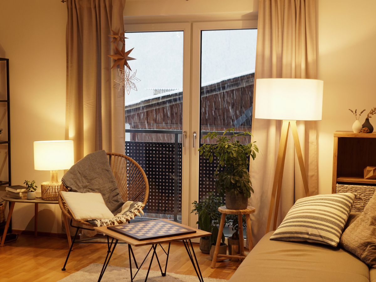 Comfortable Tenant living space featuring modern furniture, soft lighting, and rain outside