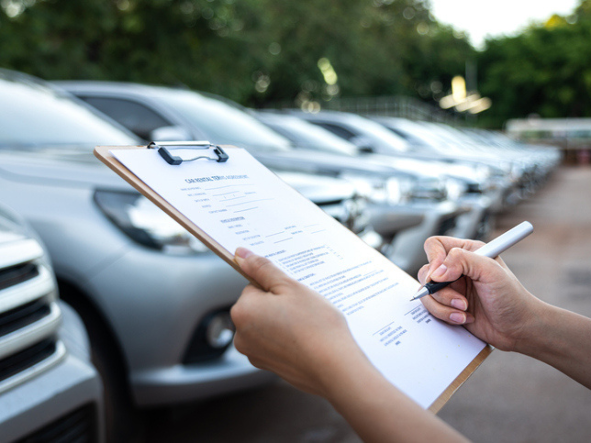 Sandbox Insurance broker reviewing fleet coverage checklist for multiple commercial vehicles in a company lot