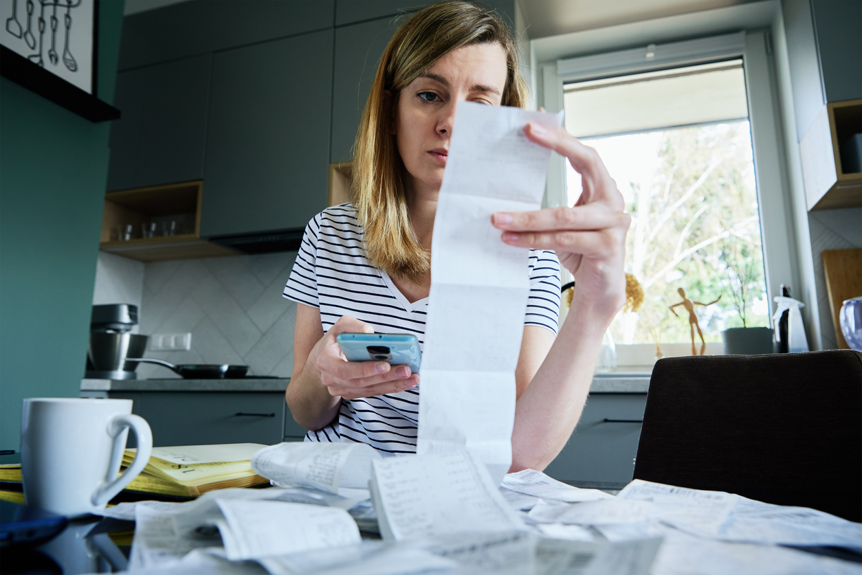 Person reviewing receipts to assist with insurance claim losses